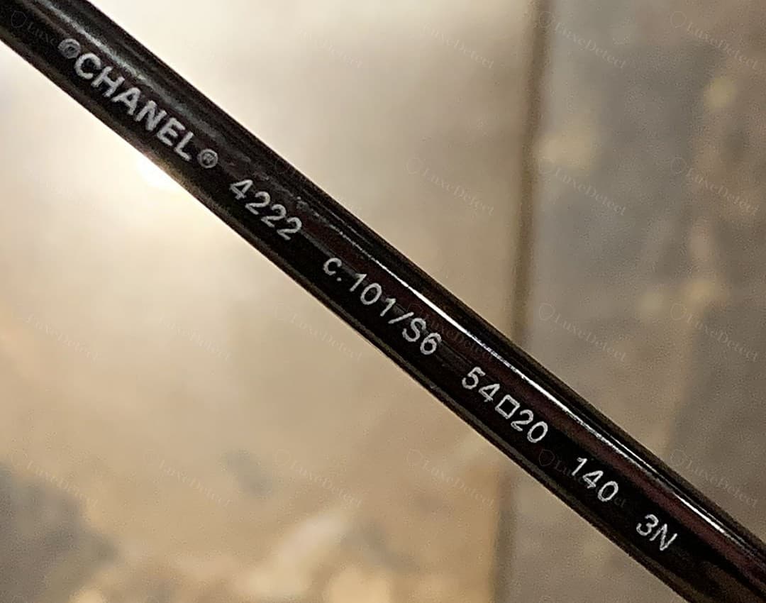 Genuine Chanel inner-temple string — "©CHANEL® 4222 c.101/S6 54▫20 140 3N" printed crisply and evenly, carrying the copyright and registered symbols, model number, colour code, size, temple length and lens category