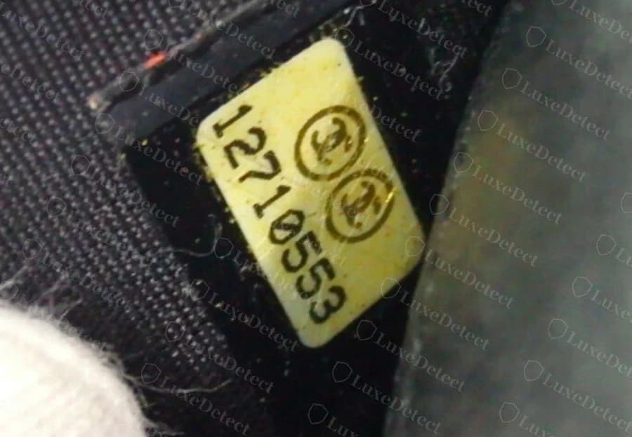 Authentic Chanel wallet serial sticker — cream oval sticker with two CC logos in a printed circle and an 8-digit serial number