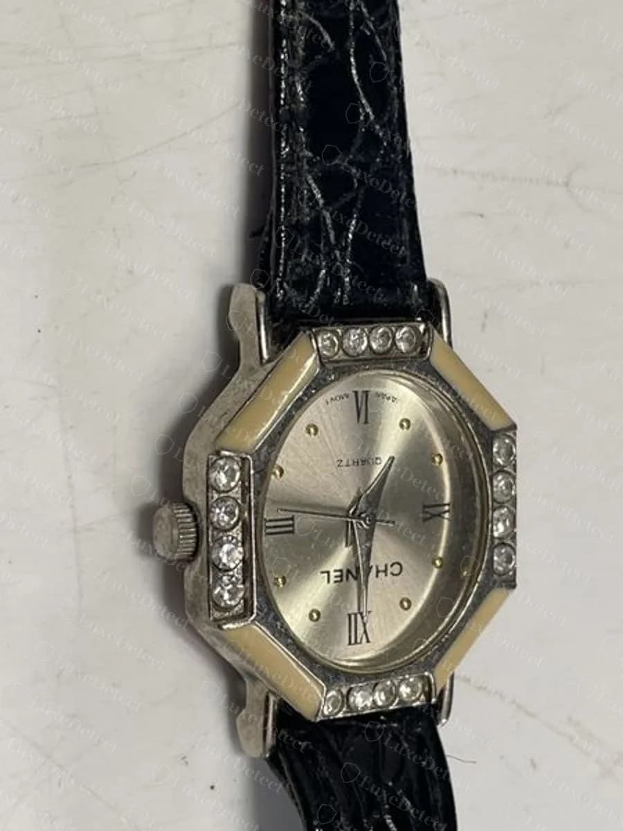 Another confirmed fake, a pavé-set octagonal dress watch on a leather strap with a Roman-numeral dial. The octagon here is a generic fashion-watch shape, not Chanel's actual Première case.