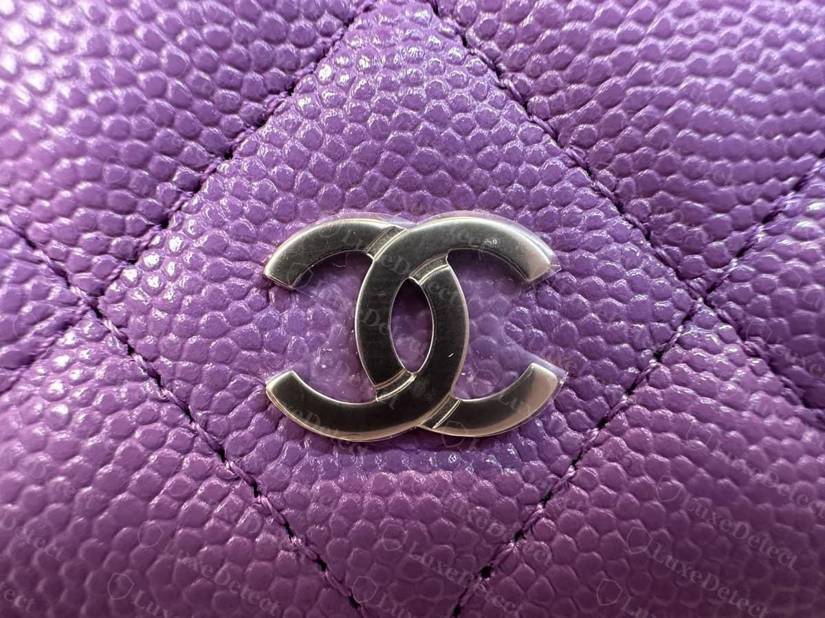 Genuine Chanel WOC CC turnlock in silver-tone metal, centred inside one quilted diamond of purple caviar leather