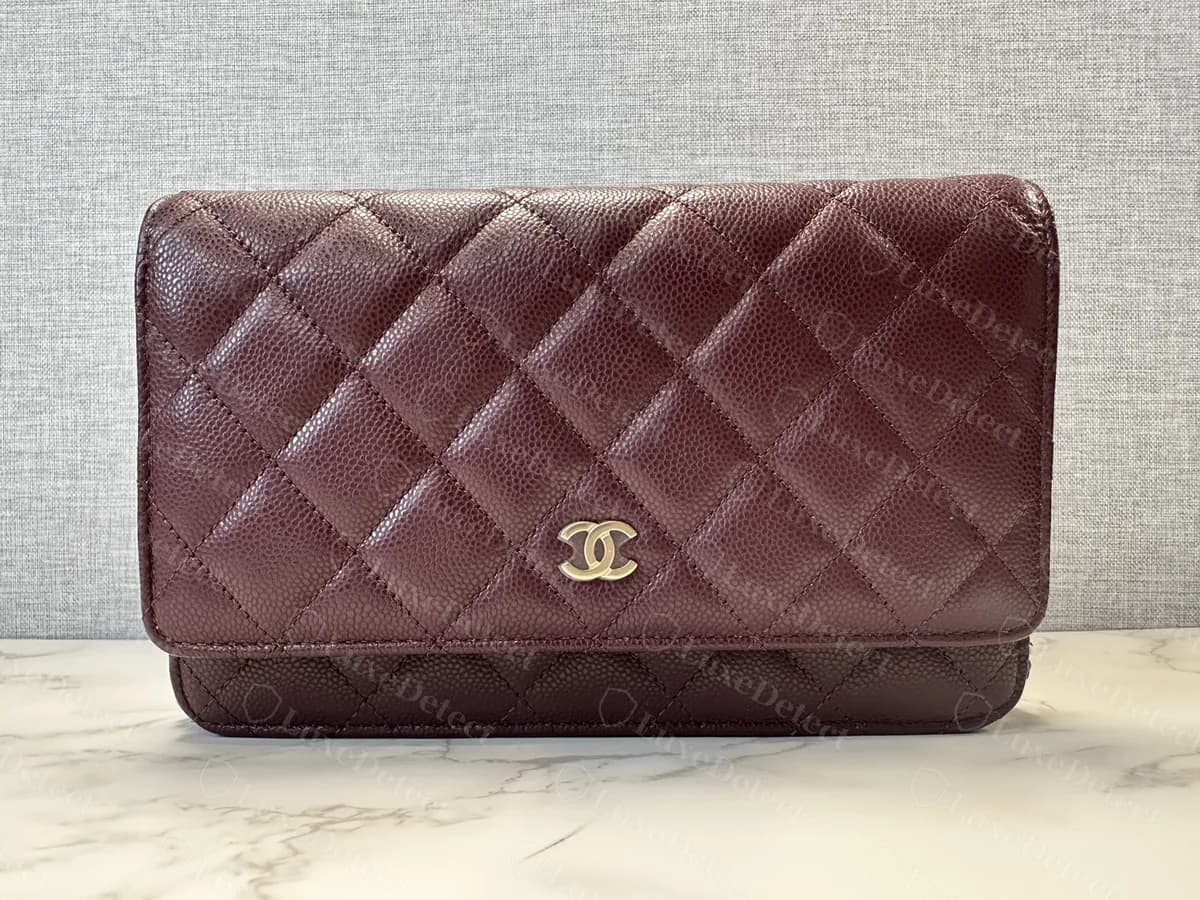 Genuine Chanel Classic Wallet on Chain in burgundy caviar leather, front view: a flap with diamond quilting and a single small CC turnlock, with the chain attached at both sides