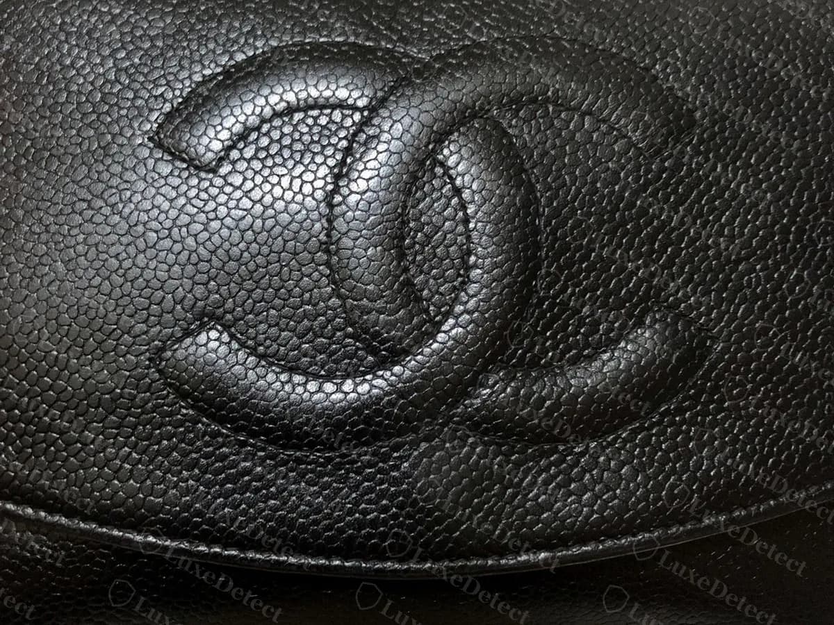 Older-style genuine Chanel Timeless wallet on chain in black caviar: a large CC quilted into the flap in place of a metal turnlock