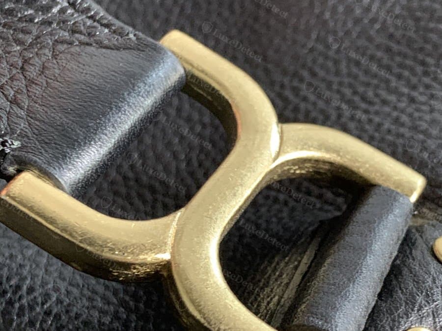 Zipper hardware on a lower-grade example — compare engraving crispness and metal finish against the authentic pull above