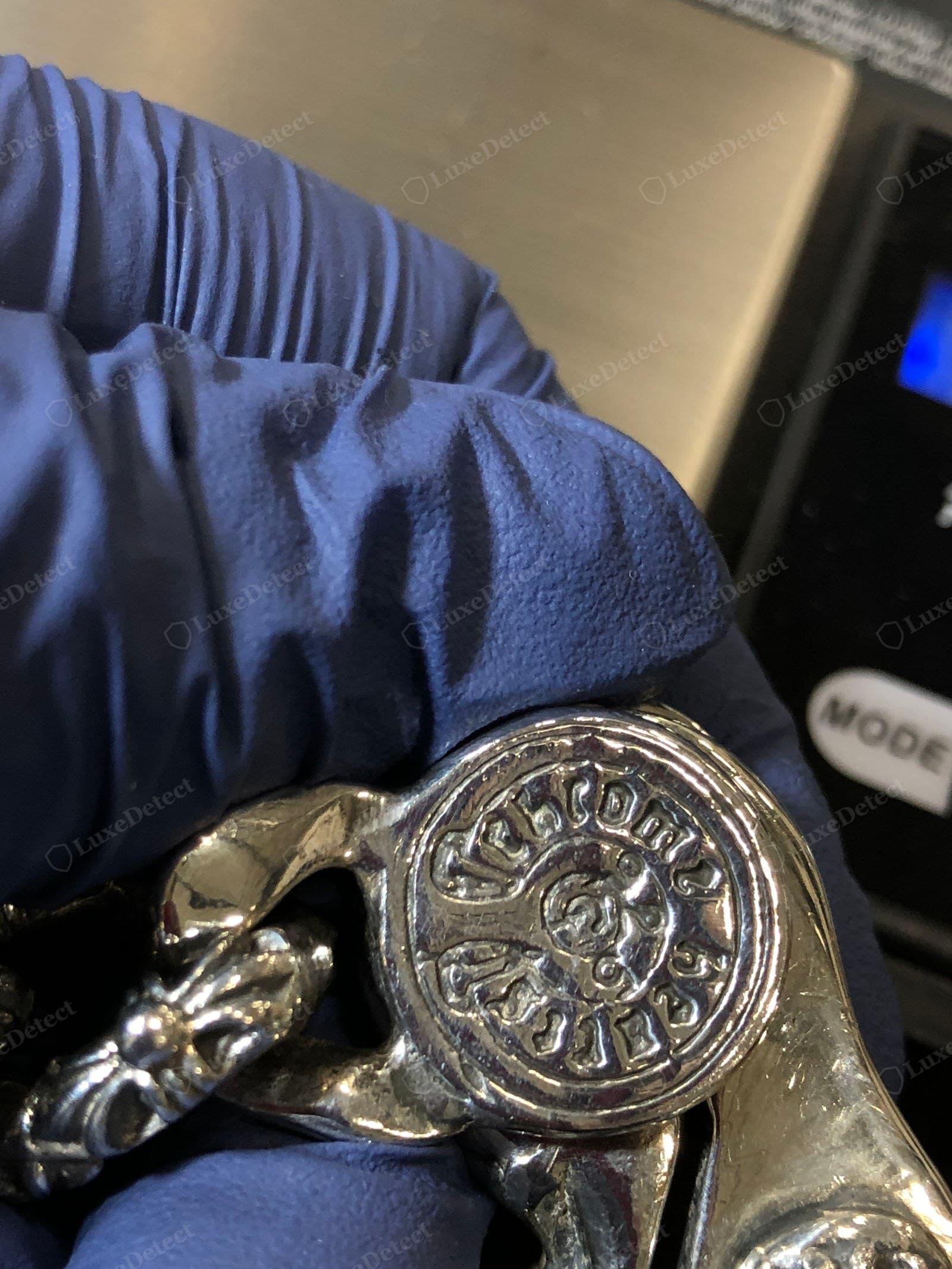 Genuine Chrome Hearts hallmark — the circular stamped disc reading "chrome hearts" and ".925" around a scroll motif, struck into high-polish sterling on a toggle clasp