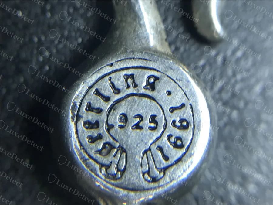Authentic: the round clasp disc on a genuine Chrome Hearts bracelet, reading "Sterling", "1991" and ".925" around the edge, each character crisp, evenly spaced and struck to the same depth