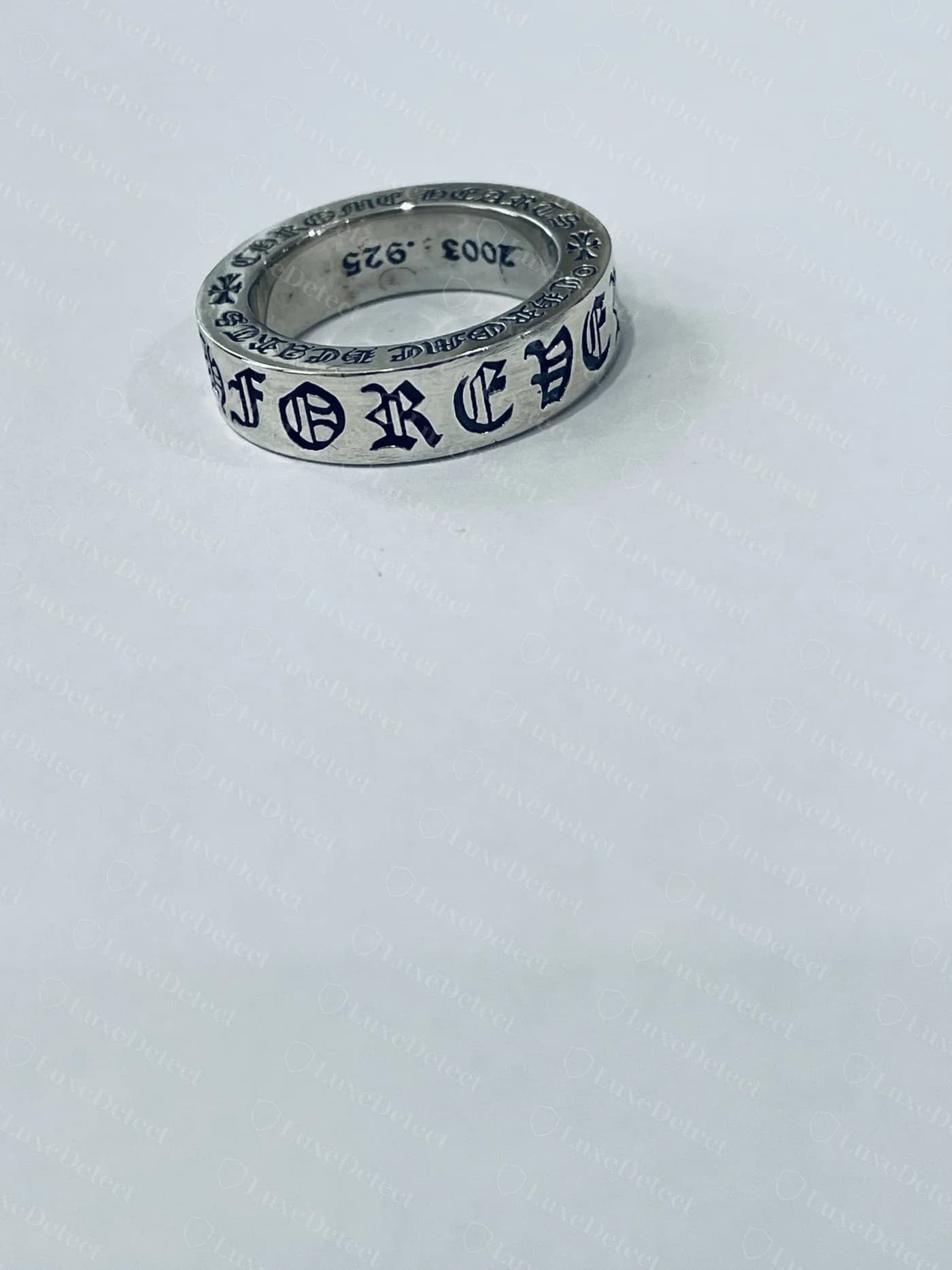 Genuine Chrome Hearts ring engraved "FOREVER" in blackletter script around the exterior band, even stroke weight and consistent letter spacing following the curve of the ring