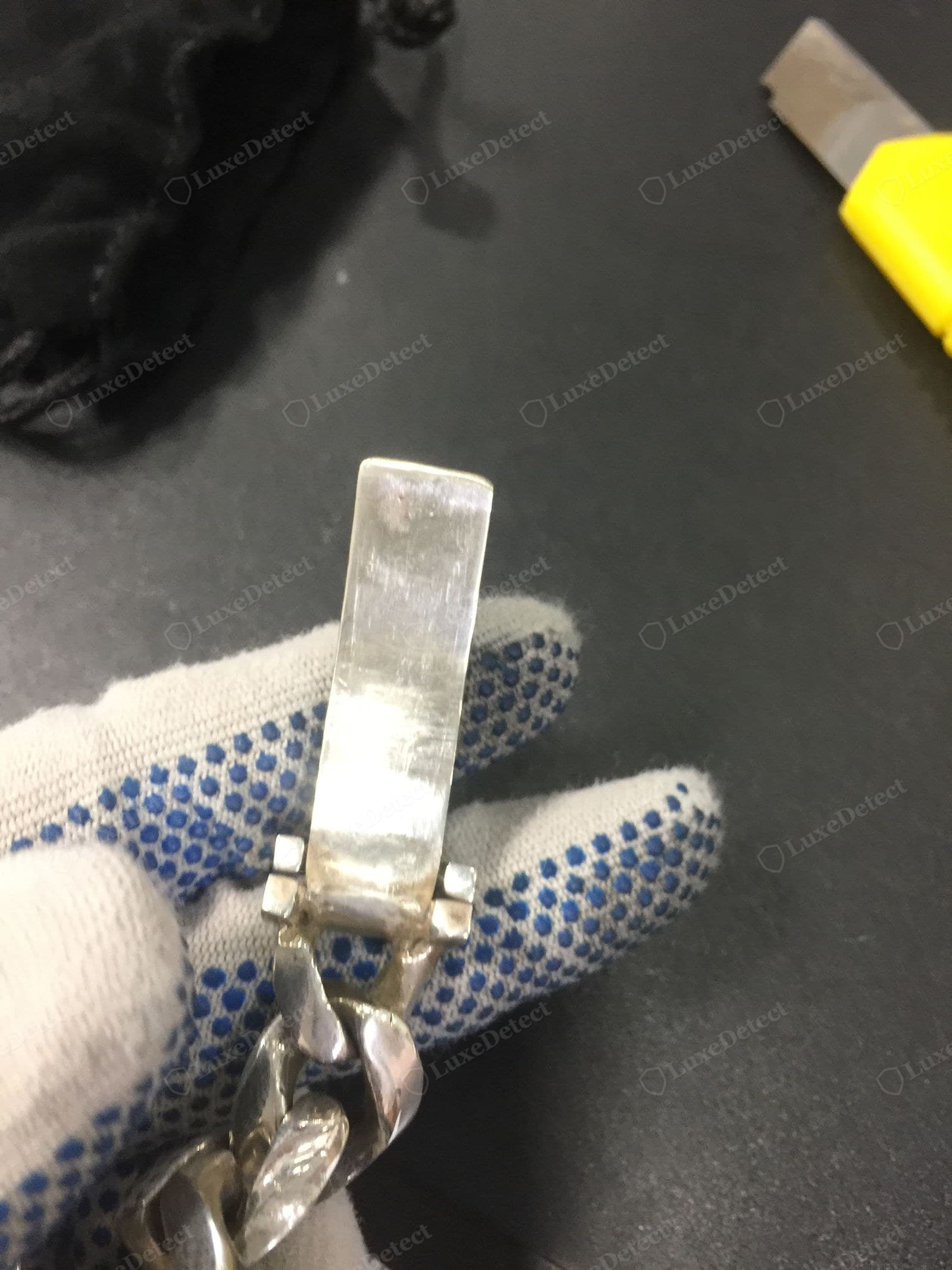 Counterfeit Chrome Hearts silver — a heavy curb-link chain with a plain box clasp, the metal bright chrome-white with surface scratches and no natural patina, the CH cross-links soft and mushy