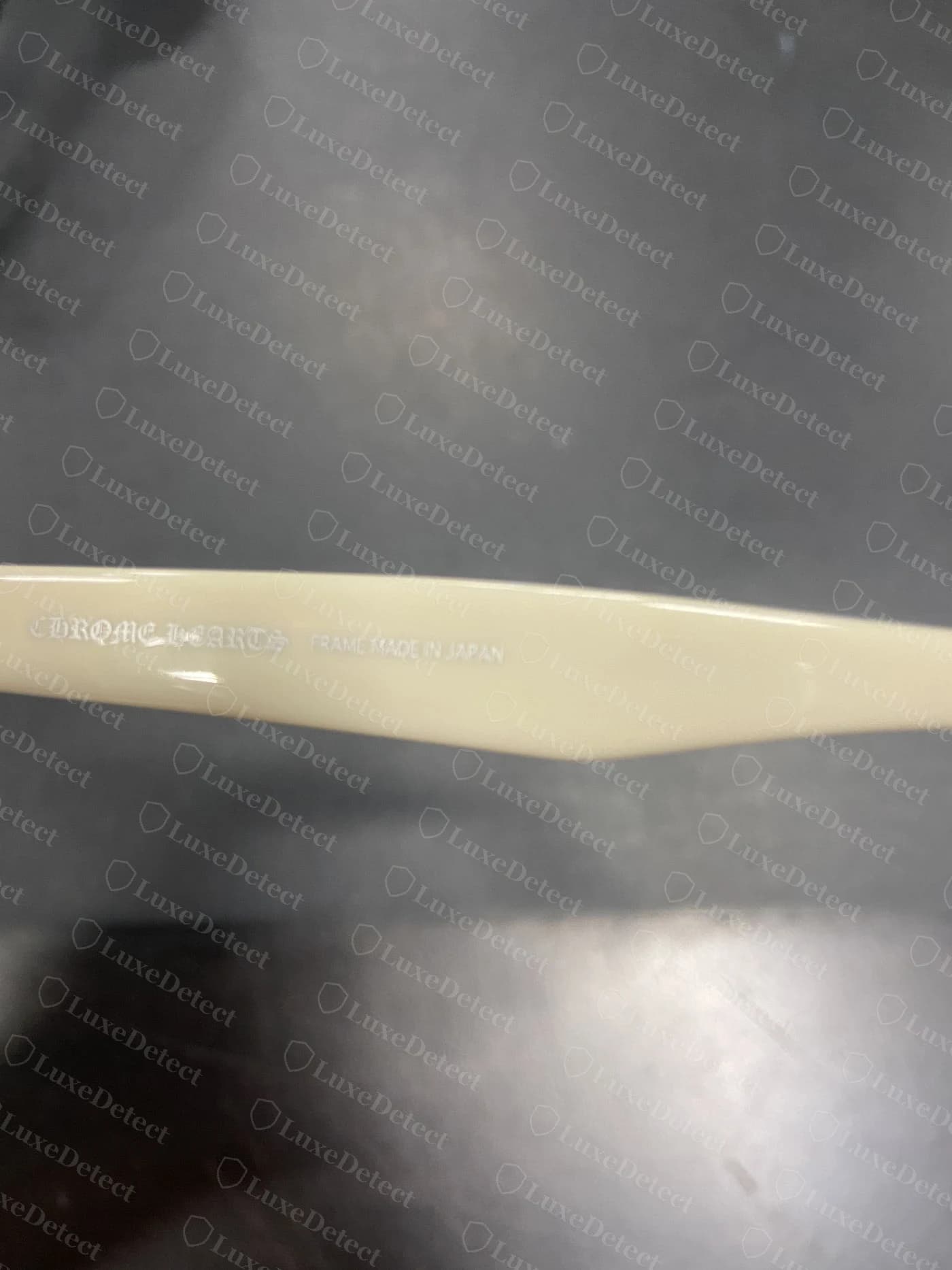 Genuine Chrome Hearts sunglasses temple — CHROME HEARTS wordmark in clean gothic blackletter alongside FRAME MADE IN JAPAN