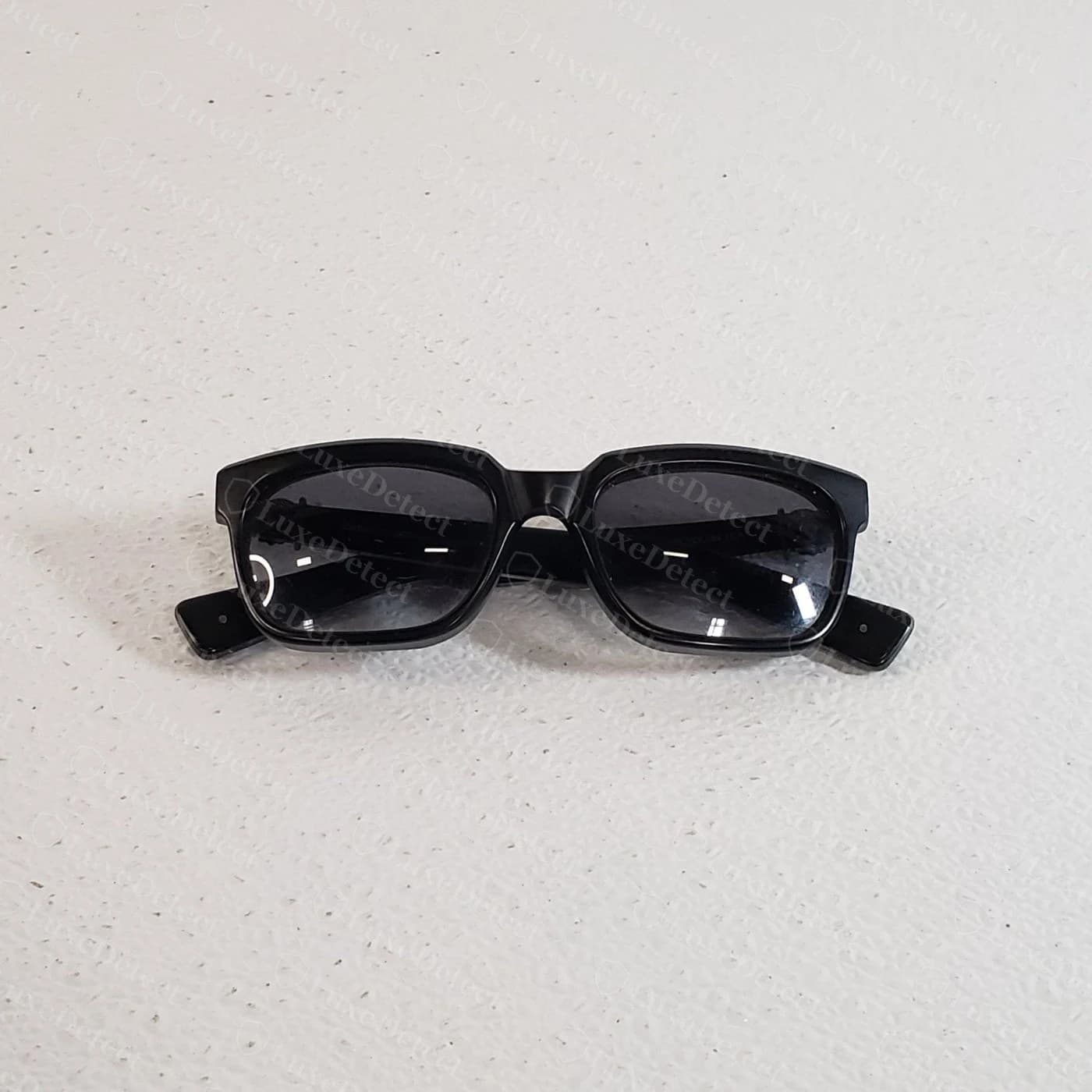 Counterfeit Chrome Hearts sunglasses — a generic acetate frame with no wordmark, no cross medallion, and no branding anywhere on the hinges or temples
