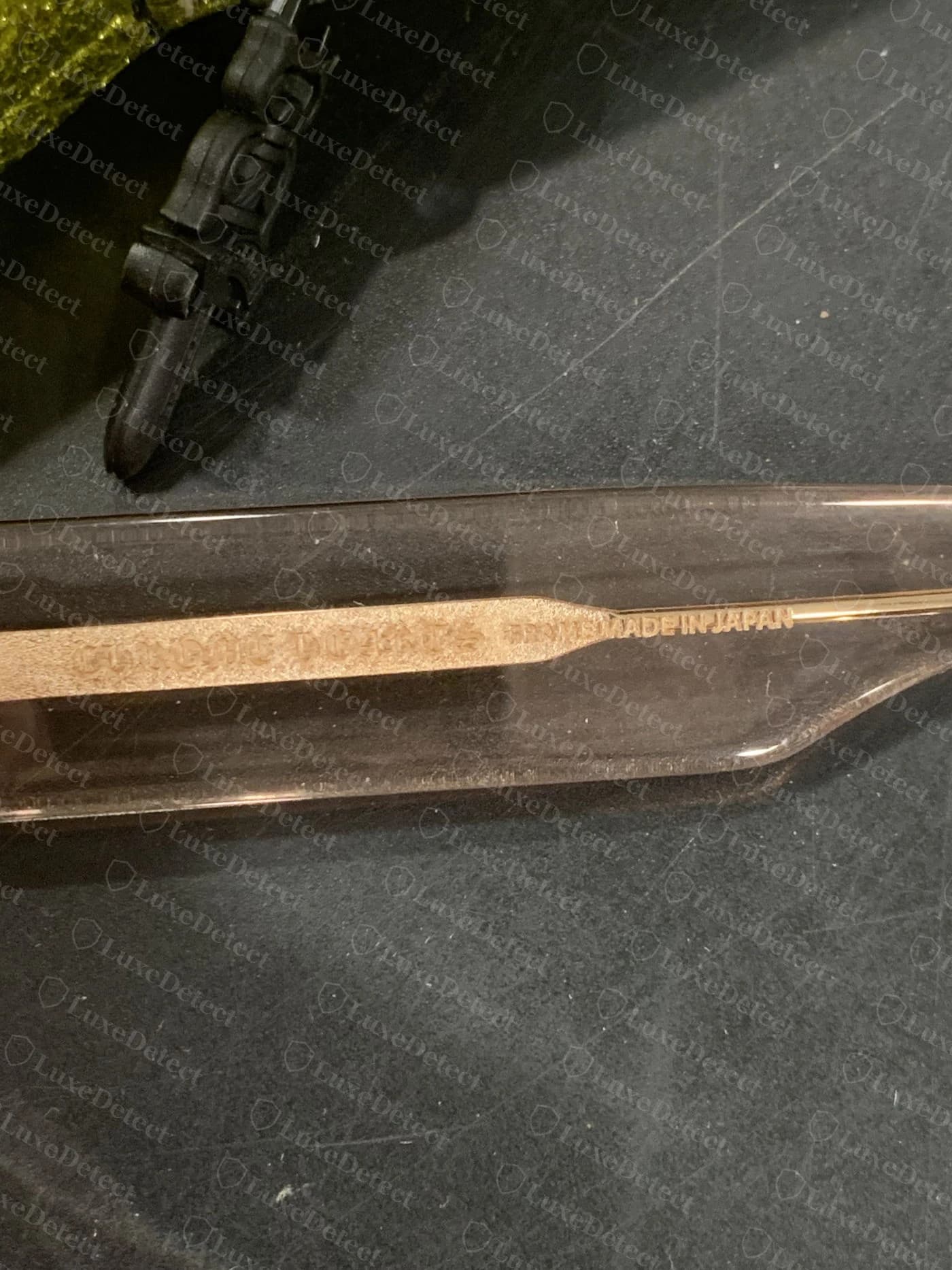 Counterfeit Chrome Hearts sunglasses temple — engraving reads CHROME DUPHES with a second stamp reading ESTREL LA, neither a real Chrome Hearts wordmark or model name
