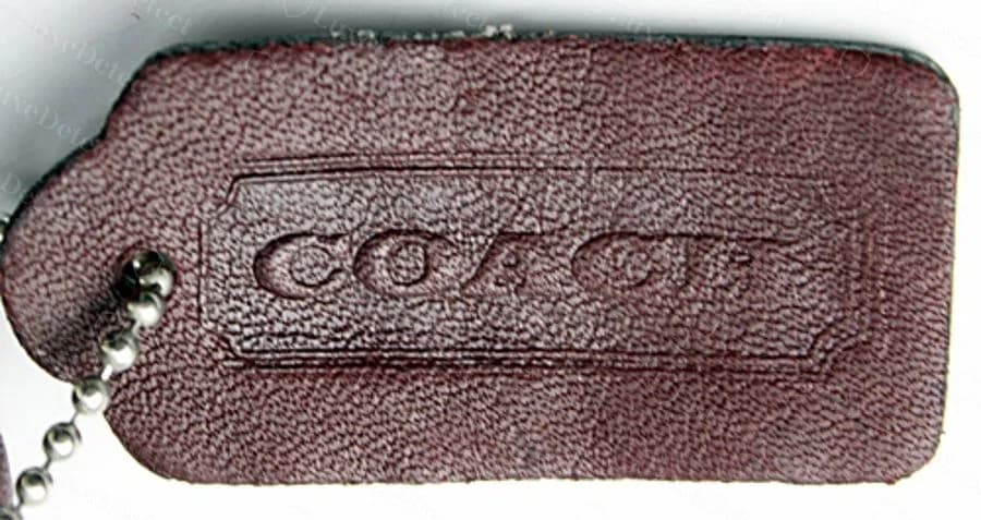 Counterfeit Legacy leather hangtag: a visibly softer, slightly less defined COACH wordmark.