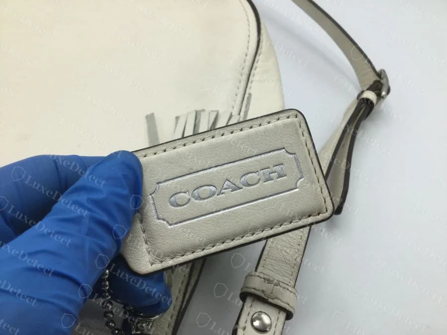 Leather Coach hangtag on a verified authentic Willis, debossed lettering inside the standard bordered box.