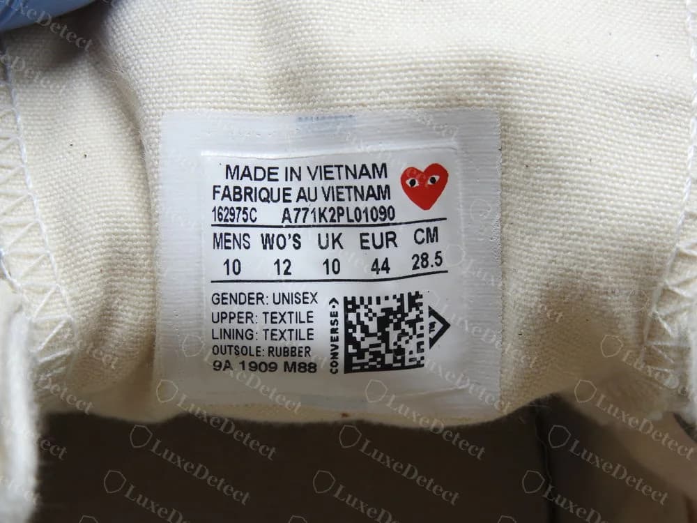 Genuine CDG PLAY x Converse Chuck 70 tongue label: MADE IN VIETNAM and FABRIQUE AU VIETNAM, a red heart, a style code, a size table, a QR code and a date line beginning 9A