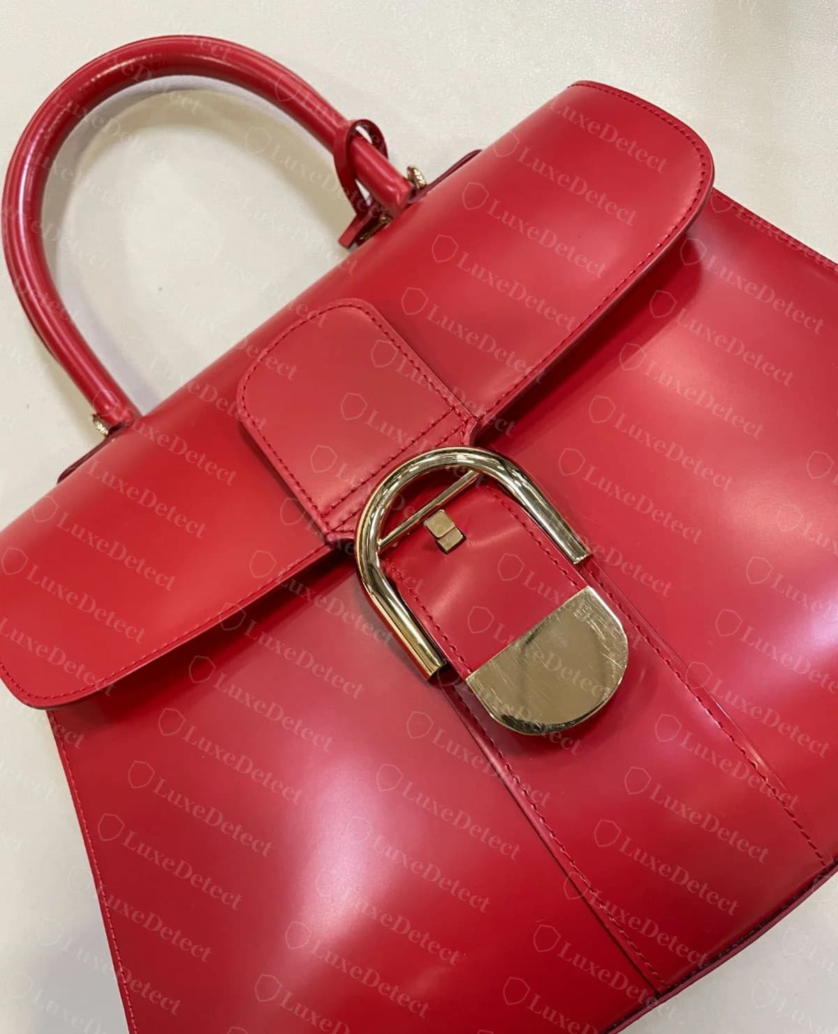 Counterfeit Delvaux Brillant, angled view, with a silhouette, D-buckle and stitching that closely match a genuine bag at a glance