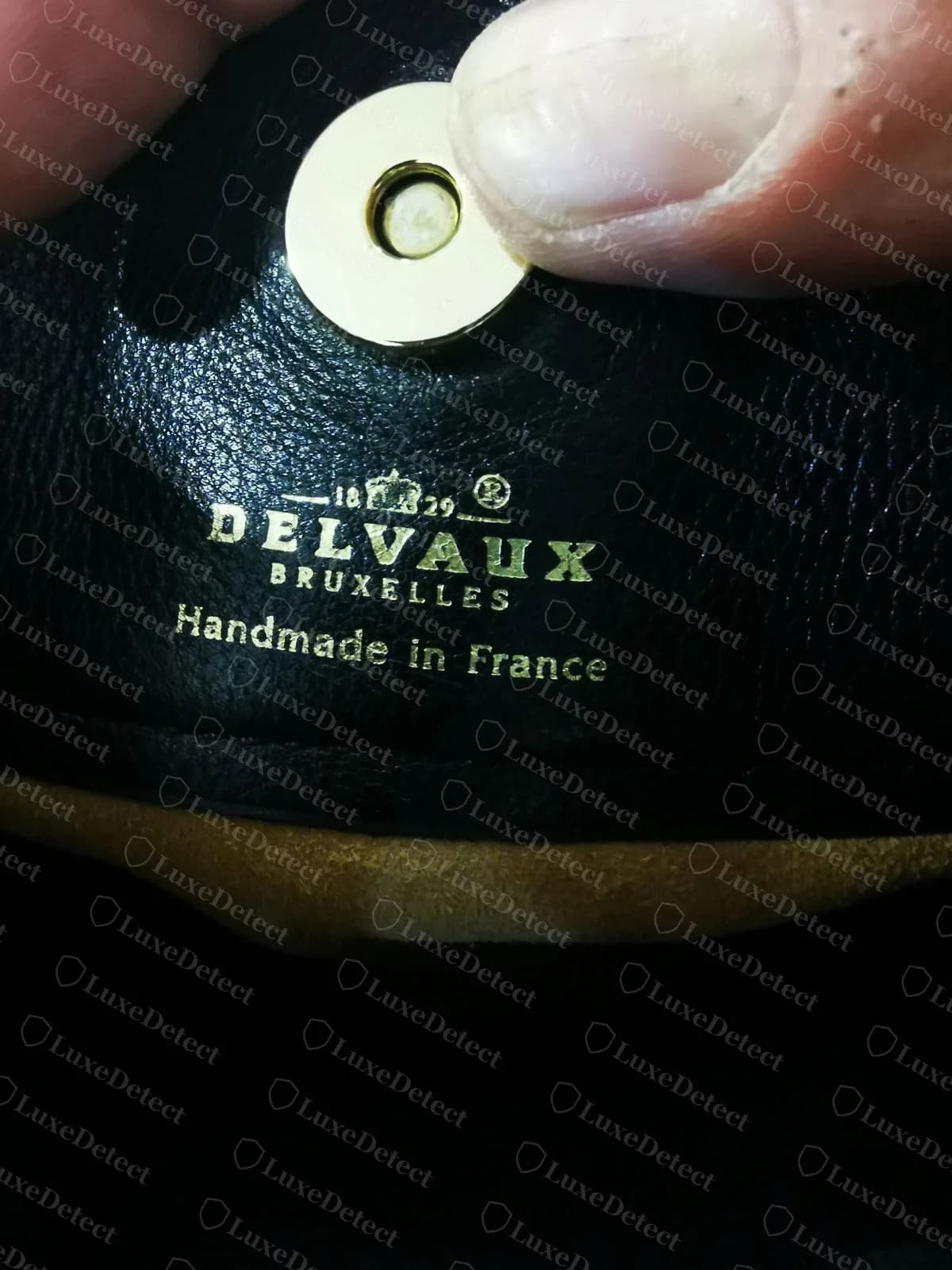 Counterfeit Delvaux Brillant interior stamp adding a third line, Handmade in France, underneath DELVAUX BRUXELLES