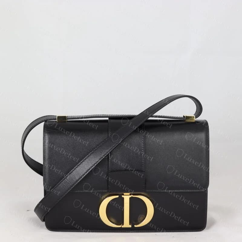 Genuine 30 Montaigne strap-end hardware stamped "Christian Dior Paris" in clean serif engraving on polished gold metal
