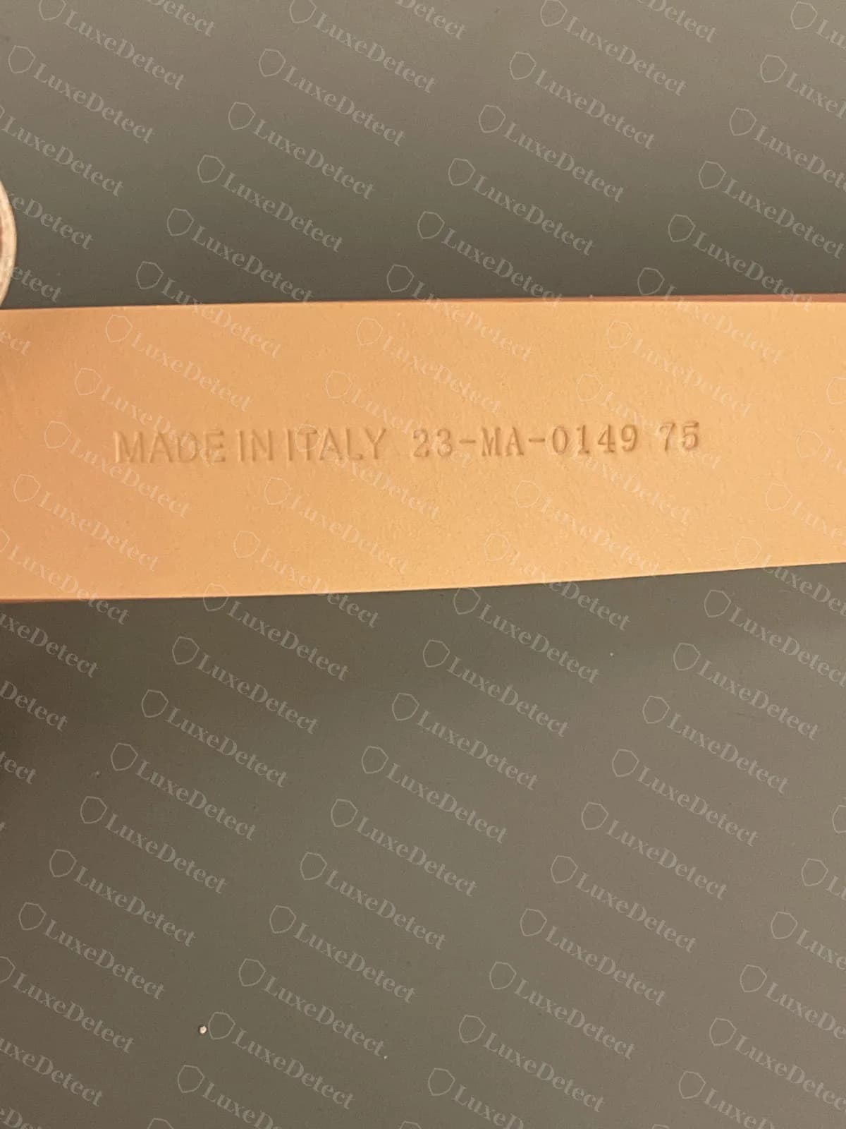 Counterfeit Dior CD belt in nude leather, stamped "MADE IN ITALY 23-MA-0149 75", the same code found on fake belts of a different model