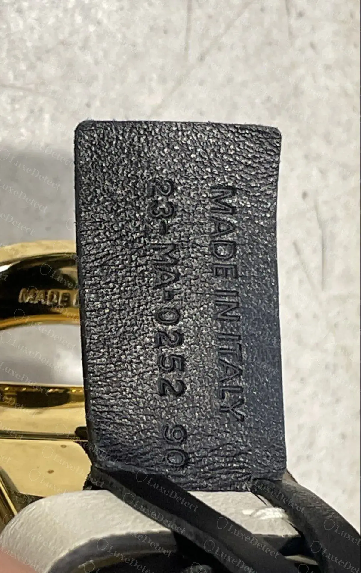 Genuine 30 Montaigne reversible belt, the leather tab stamped "MADE IN ITALY" and "23-MA-0252 90" in clean, evenly deep characters