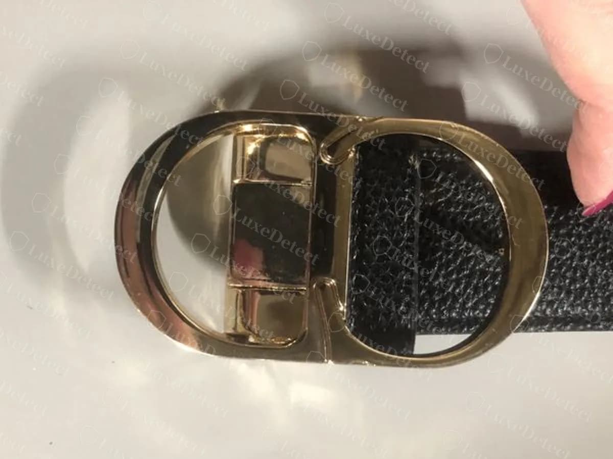 Counterfeit 30 Montaigne-style belt, the oval CD buckle in a pale, brassy finish with softer inner edges and the hinge block showing through the opening