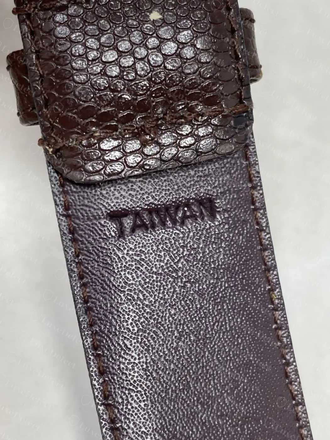 Counterfeit vintage-style Dior belt with a lizard-embossed strap, the lining also stamped "TAIWAN" in the same position as the genuine licensed belt