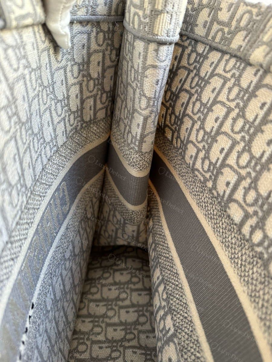 Close-up of authentic Oblique jacquard weave showing the woven CD motif structure and consistent seam alignment.