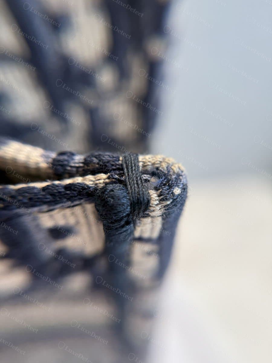 Counterfeit handle base from our archive, showing looser thread wrapping and visible fraying at the knot.