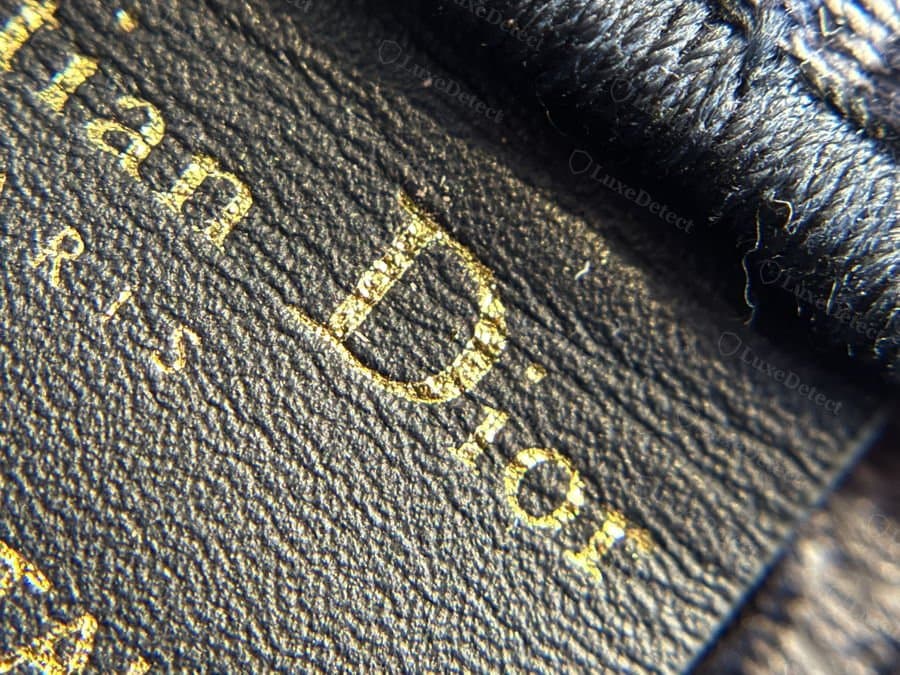 A counterfeit interior tag from our archive, reading the same "Christian Dior PARIS / MADE IN ITALY" text in a closely matched font.