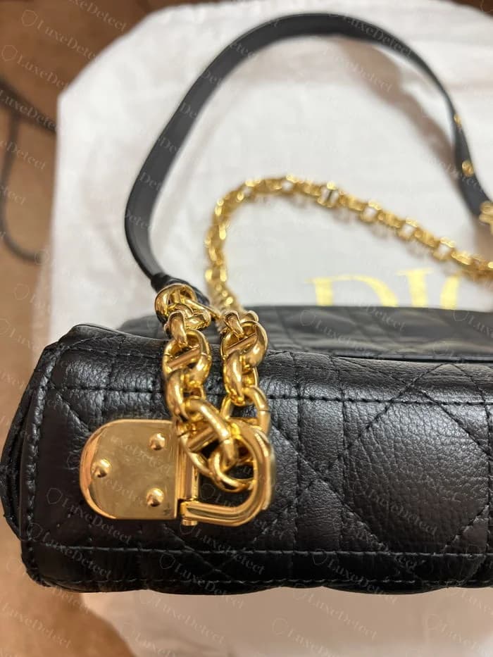 Genuine Caro chain strap detail: soldered flat-link curb chain woven through a leather strap, with a rectangular slide buckle