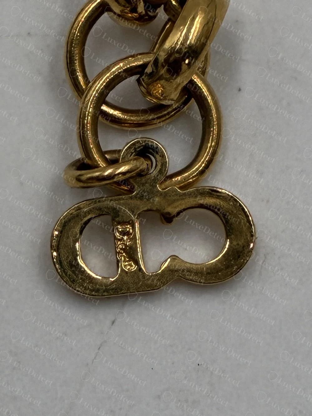 Authentic Dior CD-clasp pendant with smooth, evenly rounded cutout edges on the oval charm