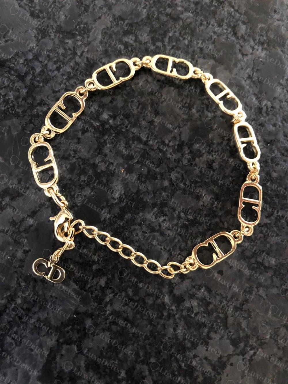 Authentic Dior bracelet built entirely from the repeating interlocking CD-oval link, each link sharing the same die-cut charm design covered in this guide