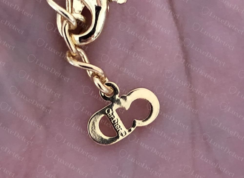 Authentic Dior CD-clasp bracelet charm with a crisp "Chr.Dior©" engraving struck cleanly into the connecting bar between the two oval lobes