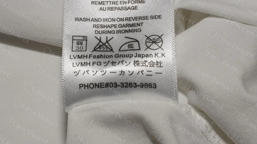 The paired wash label on a counterfeit Dior T-shirt: LVMH Fashion Group Japan K.K, Japanese lines and a phone number