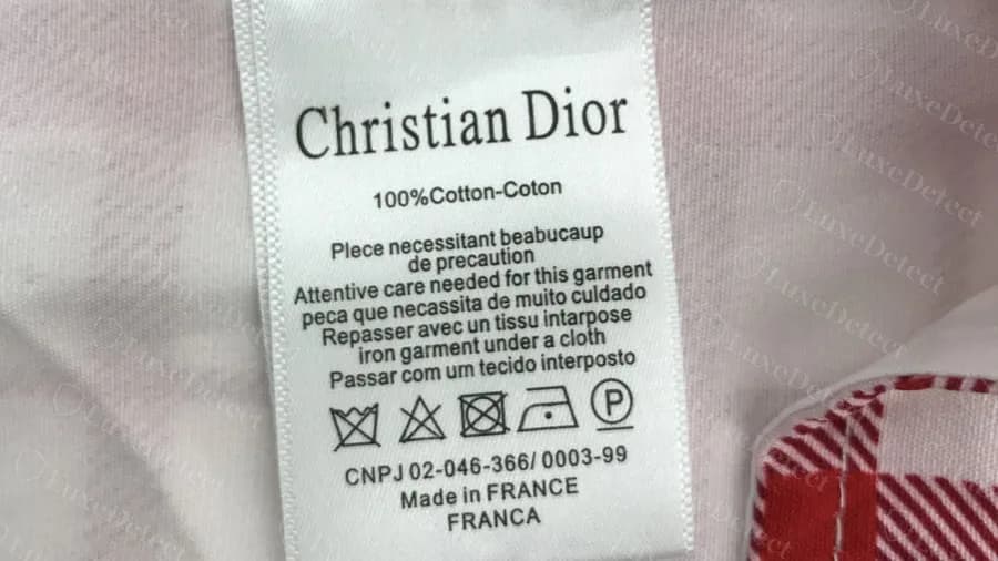 The same stub label on a counterfeit Dior plaid top, again with no style code or number