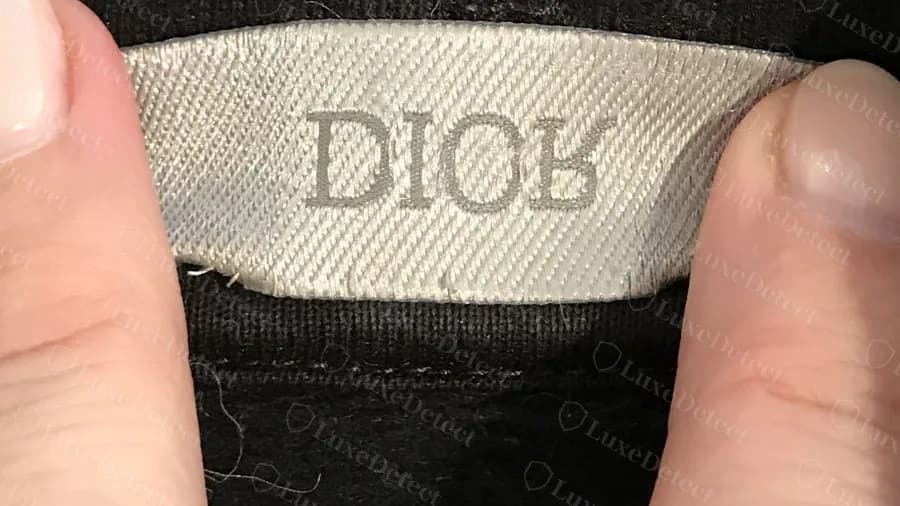 Genuine Dior neck label on an Atelier hoodie: grey woven DIOR with clean, even letters