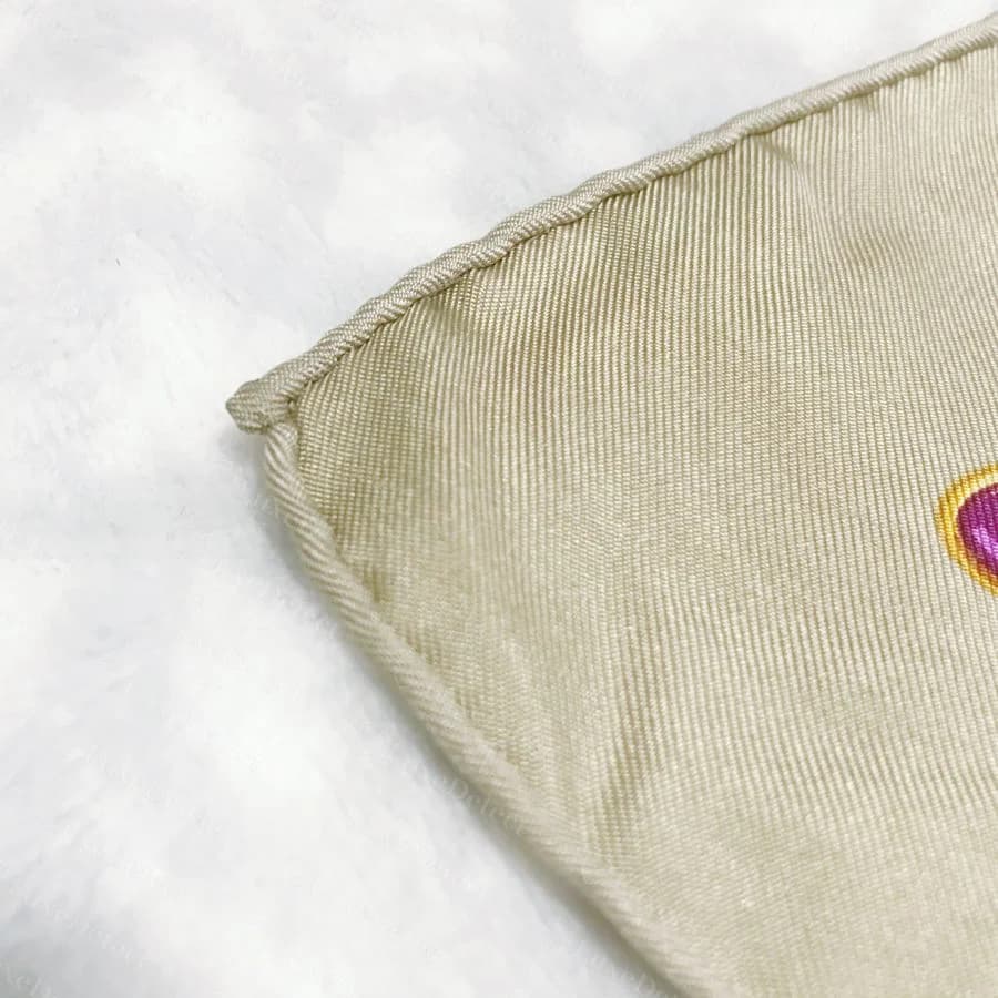 Authentic Dior silk scarf corner: a hand-rolled hem, an even tube of self-fabric with no visible machine stitching