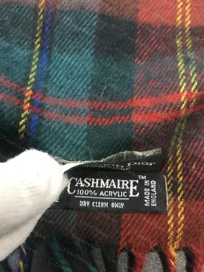 Counterfeit woven label from our sample reading "CASHMAIRE, 100% Acrylic, Made in England," a misspelled, invented sub-brand name