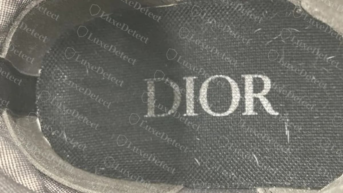 Genuine Dior B23 black insole, the same all-capitals DIOR print in grey on black (rotated to read left to right)