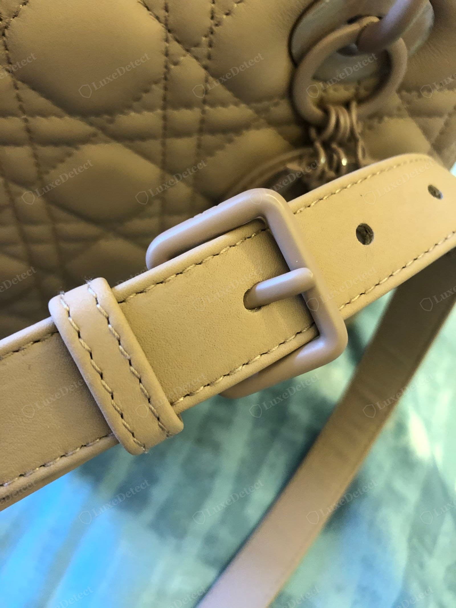 Counterfeit Lady Dior cannage — a beige fake with shallow, soft quilting, the diamonds slightly uneven in size, next to a matte-painted buckle