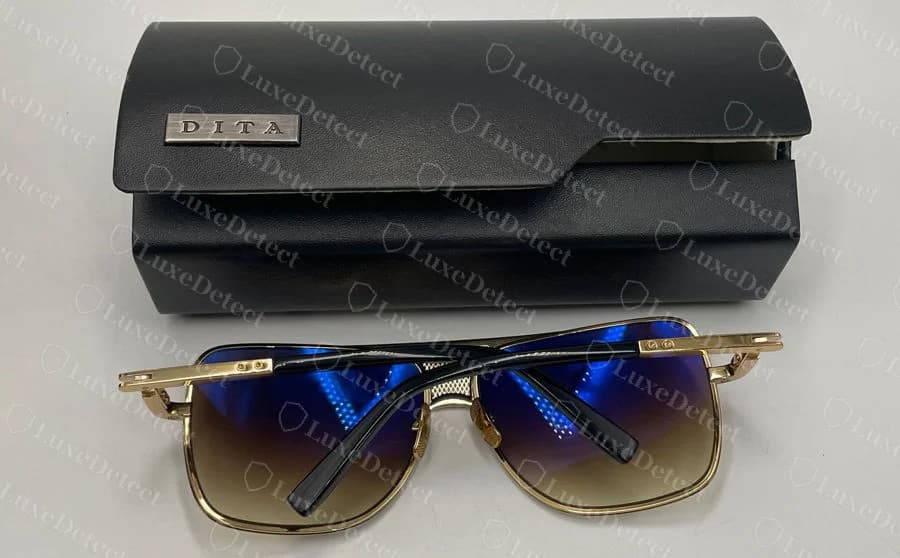 Genuine DITA sunglasses beside a black case with a metal DITA plaque on the lid