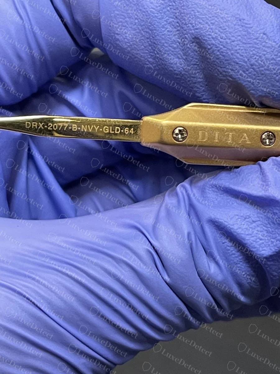 Genuine DITA Grandmaster Five temple engraved DRX-2077-B-NVY-GLD-64 beside the DITA name on the gold hinge plate