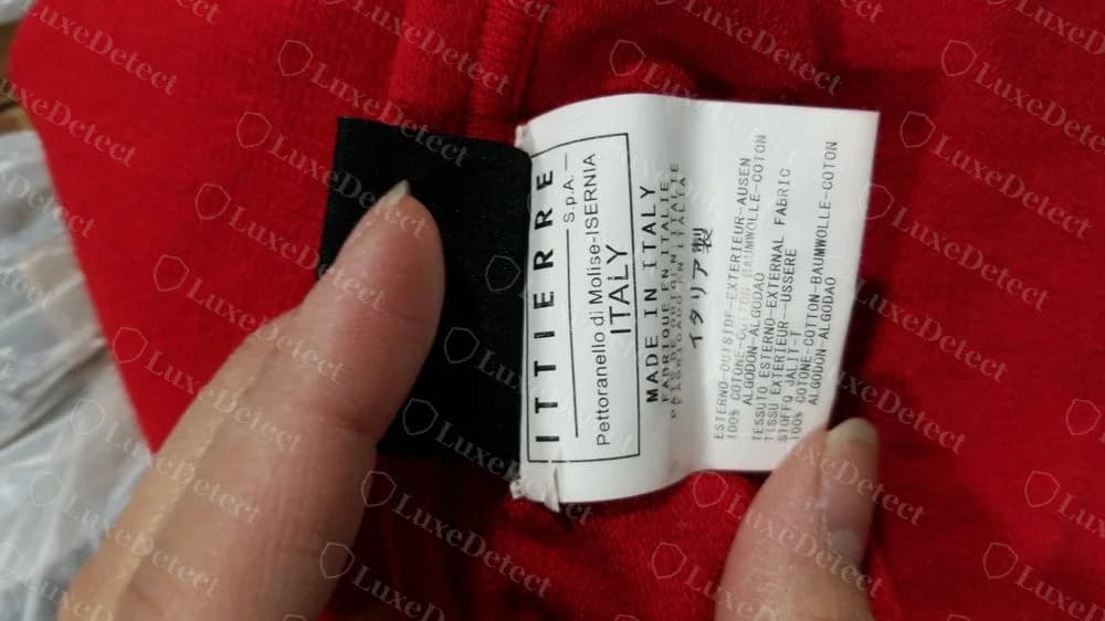 Counterfeit red dress with a copied Ittierre S.p.A. label: Pettoranello di Molise-ISERNIA, Made in Italy and fibre content in several languages