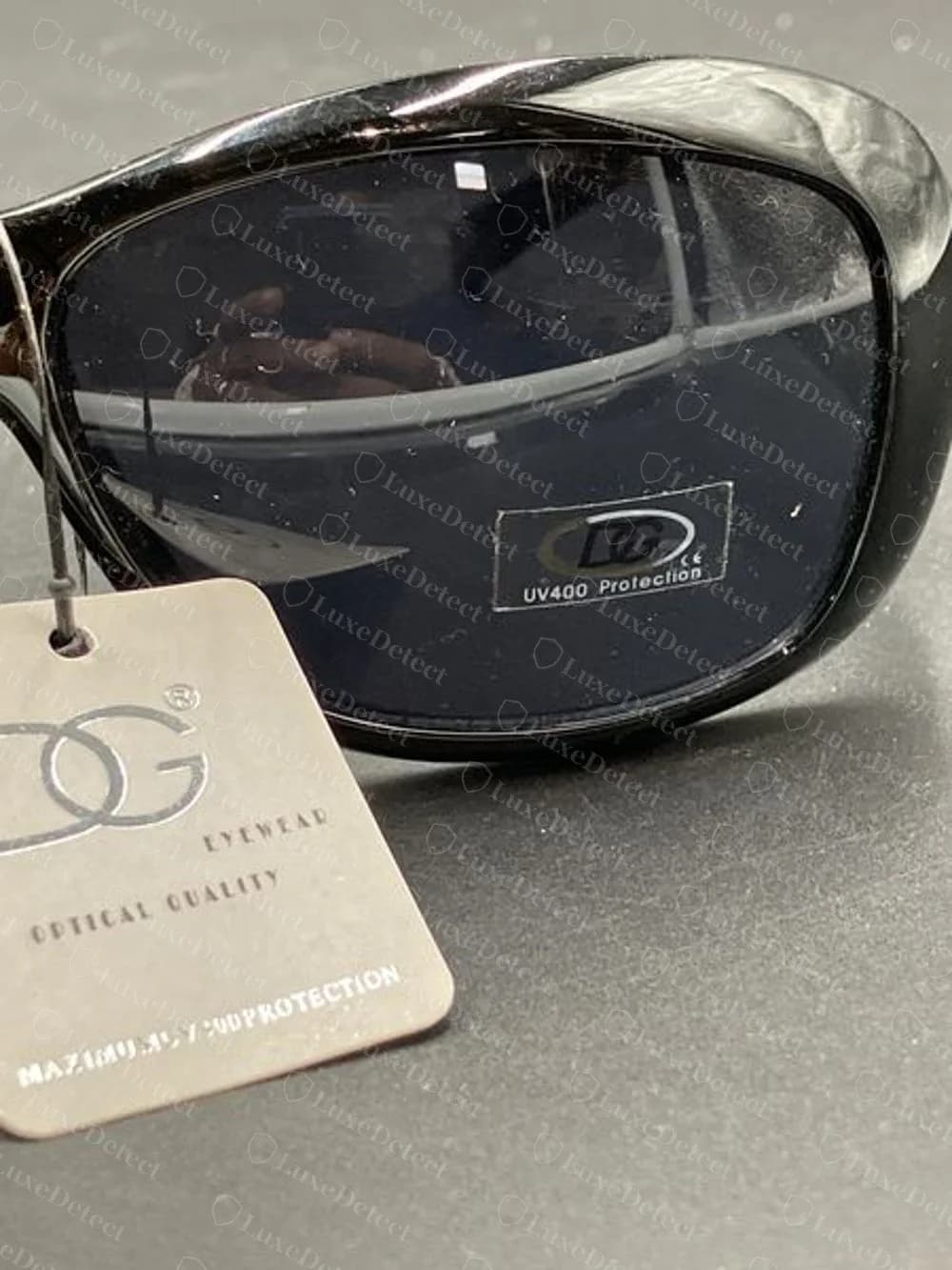 Fake pair with a DG EYEWEAR hang tag and a DG UV400 Protection sticker on the lens
