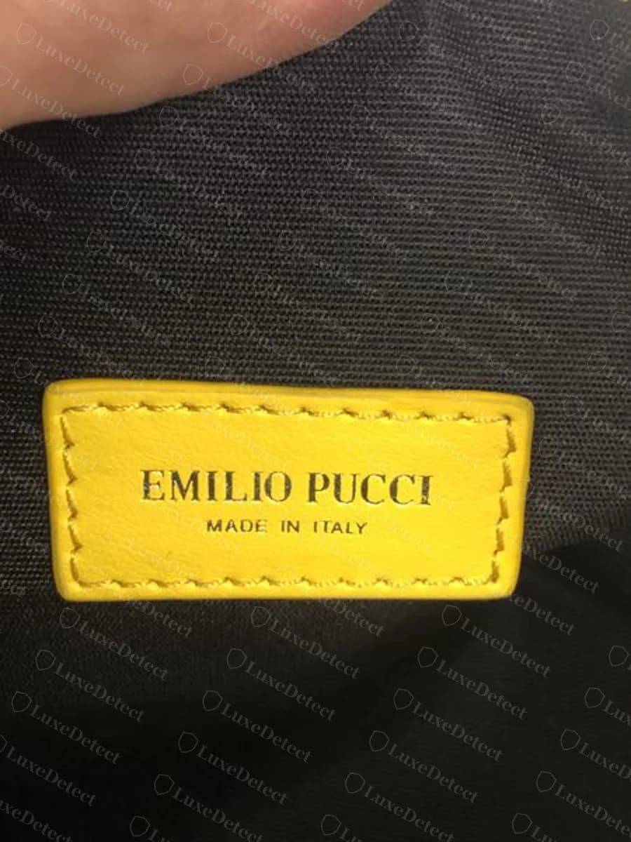 Genuine Emilio Pucci yellow leather tab stitched inside a printed case reading EMILIO PUCCI MADE IN ITALY on black lining