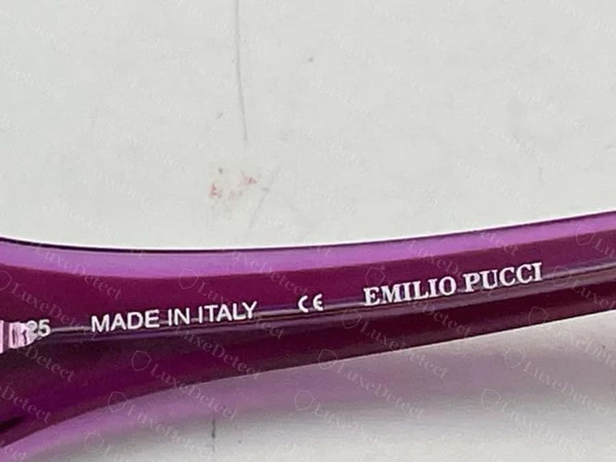 Genuine Emilio Pucci sunglasses temple interior printed with MADE IN ITALY, a CE mark and EMILIO PUCCI on a purple frame