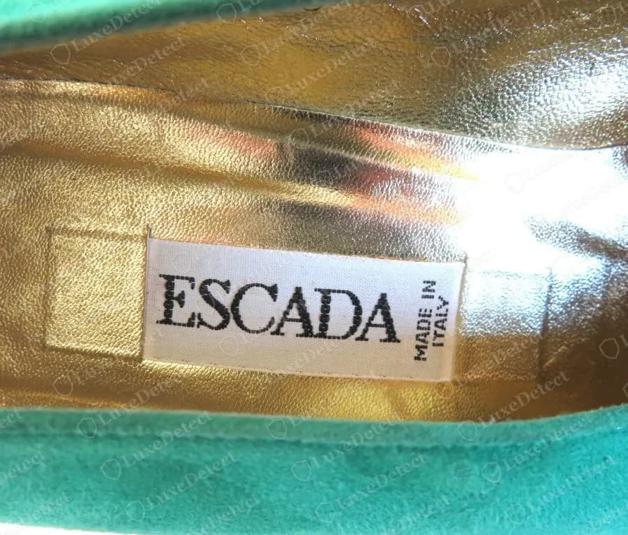 Genuine Escada white insole label with ESCADA in black serif capitals and MADE IN ITALY printed vertically, set into a gold insole of a turquoise suede shoe