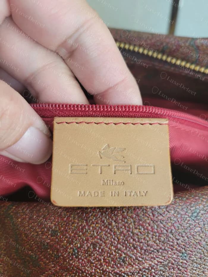 Genuine Etro tan leather interior tag stitched into a red lining, embossed with a winged horse, ETRO, Milano and MADE IN ITALY