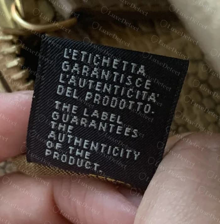 Genuine Fendi guarantee label on an older Peekaboo: L'ETICHETTA GARANTISCE L'AUTENTICITA' DEL PRODOTTO over THE LABEL GUARANTEES THE AUTHENTICITY OF THE PRODUCT, in white on black