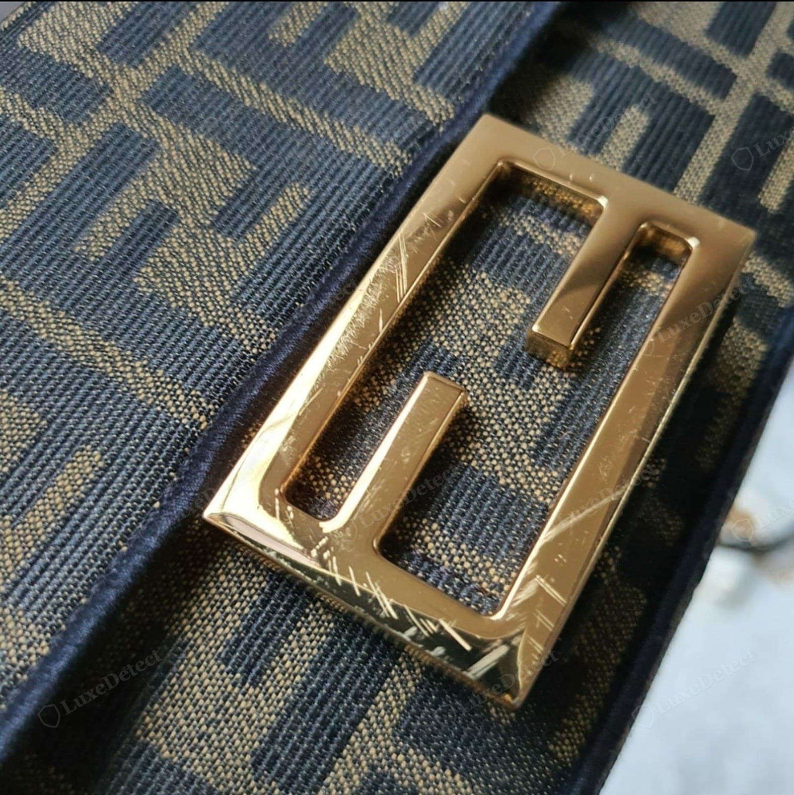 Counterfeit Fendi Baguette — FF motifs that vary in size or weight, a soft or blobby metal FF logo, motifs mis-registered at a seam