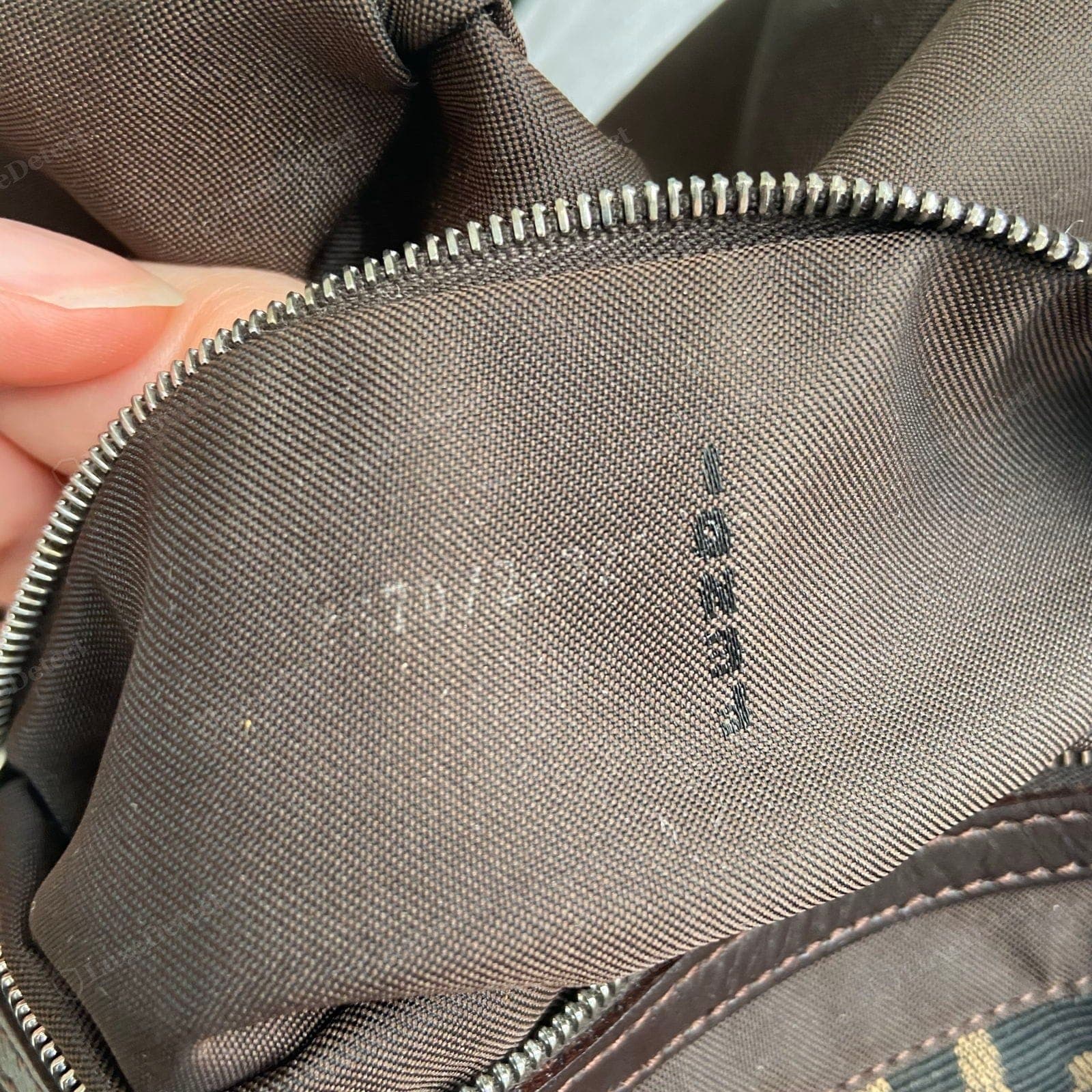 Genuine Fendi Baguette interior stamp — "FENDI" over "ROMA" / "MADE IN ITALY" and a heat-stamped model/serial code, cleanly and evenly pressed
