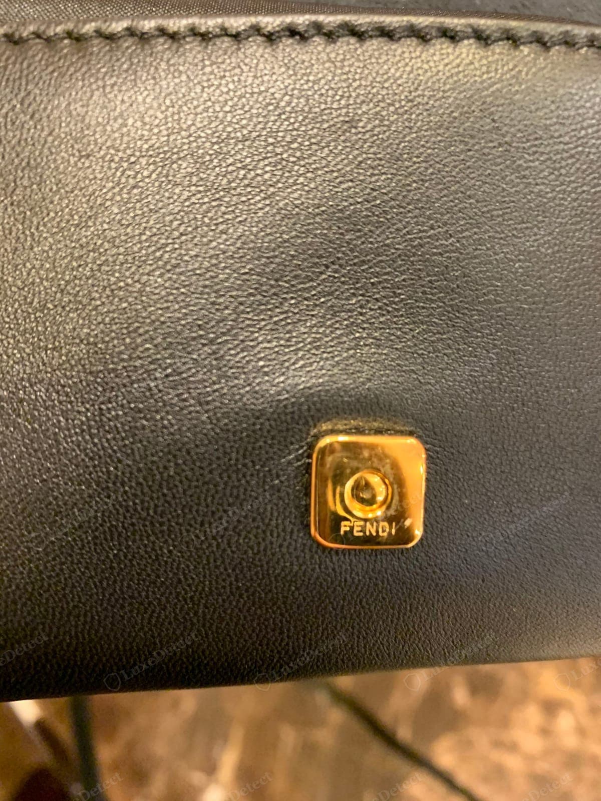 Genuine Fendi Baguette snap closure — the flap seating flush, the concealed magnet holding firmly with a clean multi-click feel